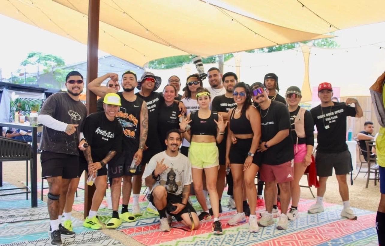 AM Club group portrait under a shade sail