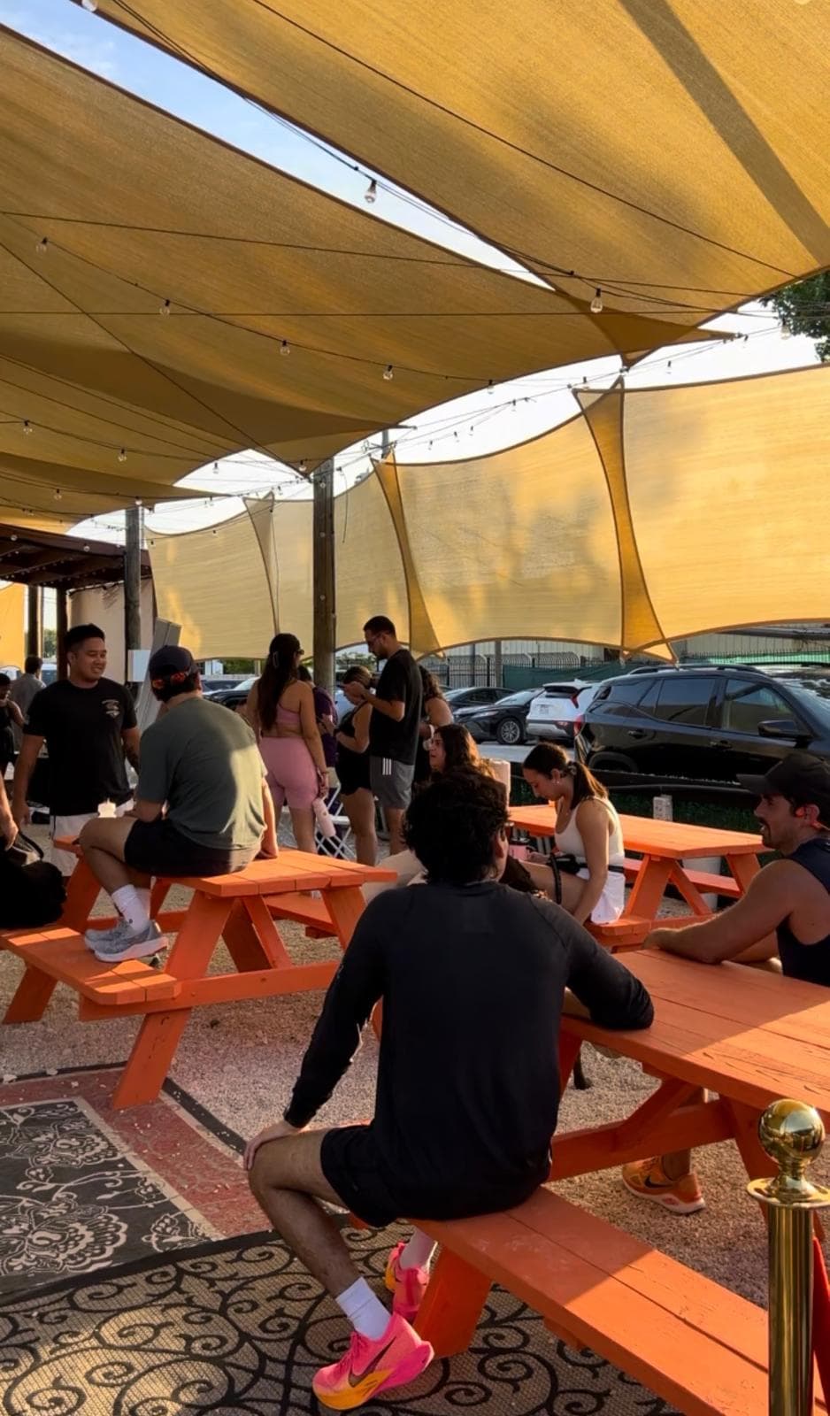Guests at picnic tables under shade sails